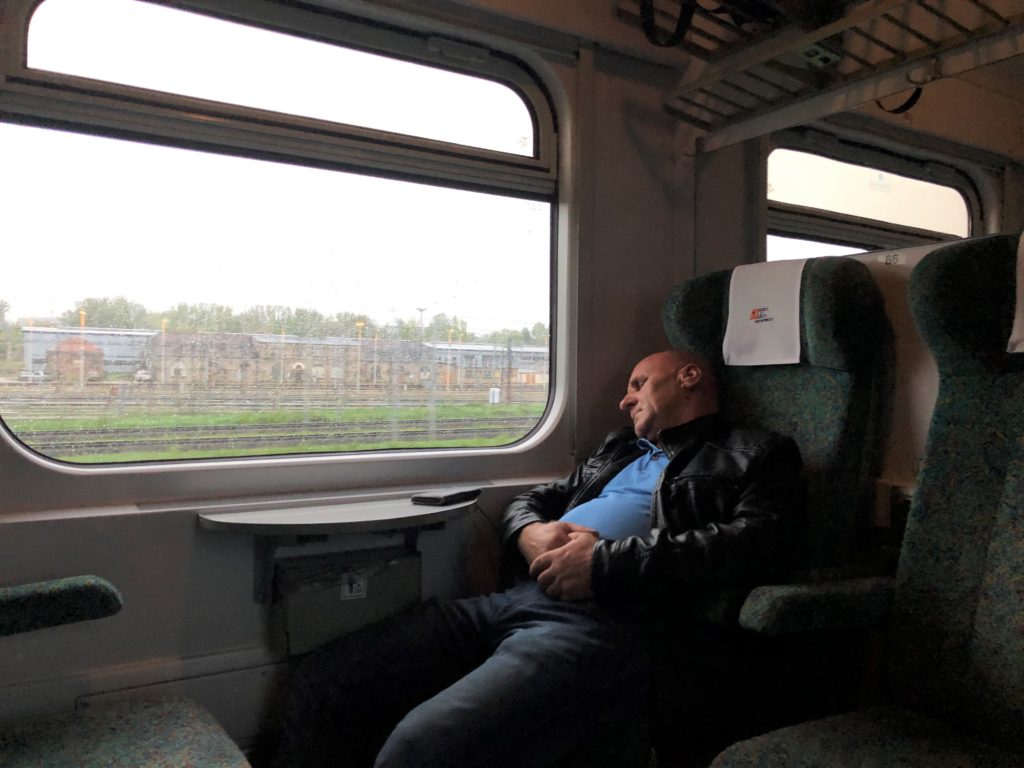 ポーランドの鉄道のコンパートメントタイプの座席と寝るおじさん